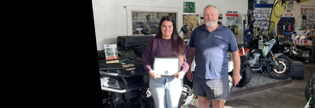 Sarah receiving her Parts Apprenticeship Certificate from MITO with Shayn