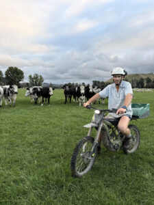 Surron Farm Bikes William in front of his dairy herd